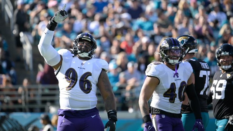 Baltimore Ravens defensive tackle Broderick Washington (96) celebrates after sacking Jacksonville Jaguars quarterback Trevor Lawrence (16) during the first half of an NFL football game, Sunday, Nov. 27, 2022, in Jacksonville, Fla. (AP)