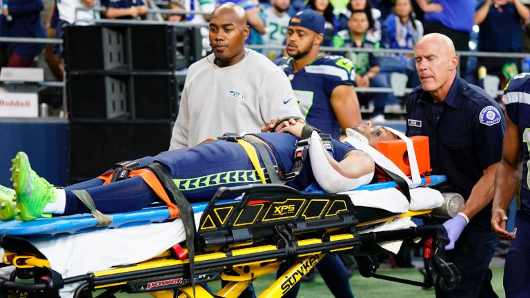 Seattle Seahawks wide receiver Cade Johnson is carted off the field during the first half of an NFL preseason football game against the Minnesota Vikings in Seattle, Thursday, Aug. 10, 2023. (Lindsey Wasson/AP)