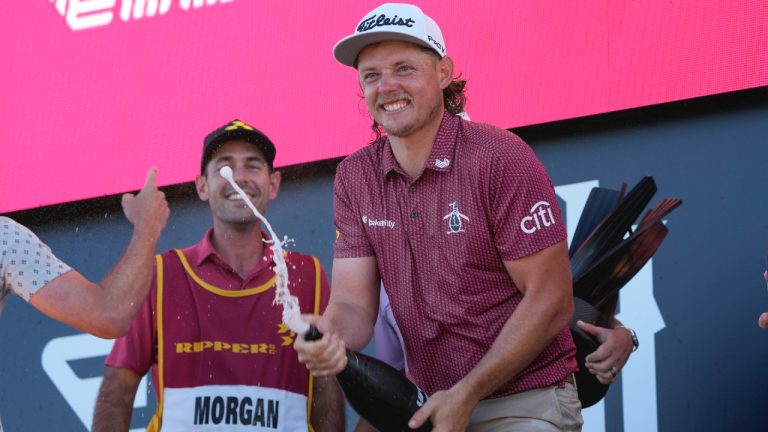 Cameron Smith, of Australia, sprays champagne during the awards ceremony after winning the Bedminster Invitational LIV Golf tournament in Bedminster, N.J., Sunday, Aug. 13, 2023. (Seth Wenig/AP)