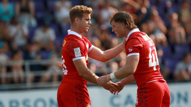 Team Canada's Jack Carson, left, congratulates teammate Lockie Kratz following a try against Team Jamaica during men's rugby action at the Rugby Sevens Paris 2024 Olympic qualification event at Starlight Stadium in Langford, B.C., on Saturday, August 19, 2023. (Chad Hipolito/CP)