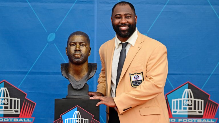 Former NFL player Darrelle Revis poses with his bust during his induction into the Pro Football Hall of Fame in Canton, Ohio, Saturday, Aug. 5, 2023. (David Dermer/AP)