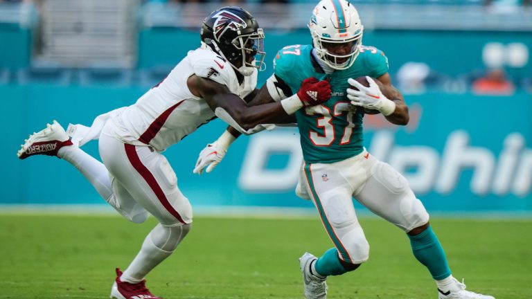 Miami Dolphins running back Myles Gaskin (37) is stopped by Atlanta Falcons linebacker Mykal Walker (3) during the first half of a preseason NFL football game, Friday, Aug. 11, 2023, in Miami Gardens, Fla. (Wilfredo Lee/AP)