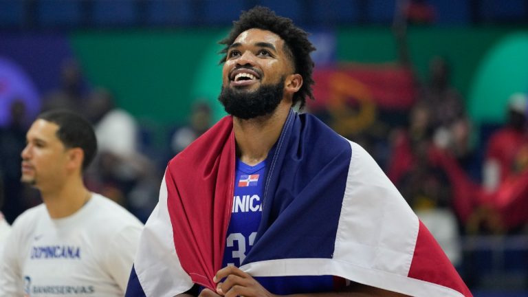 Dominican Republic forward Karl-Anthony Towns (32) celebrates after winning against Angola during their Basketball World Cup group A match at the Araneta Coliseum, Manila, Philippines on Tuesday, Aug. 29, 2023. (Aaron Favila/AP)