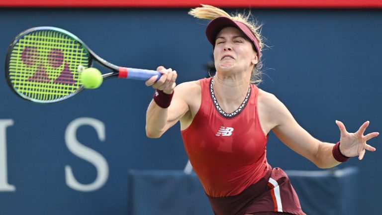 Eugenie Bouchard, from Canada, returns the ball to Danielle Collins, from the United States, during their qualifying match at the National Bank Open tennis tournament in Montreal, Saturday, August 5, 2023. (Graham Hughes/CP)