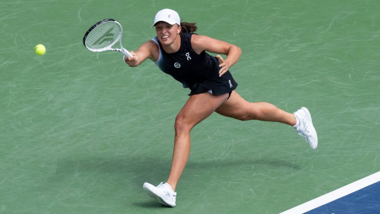 Iga Swiatek of Poland, stretches for the ball against Jessica Pegula of the United States, during semifinal action at the National Bank Open tennis tournament in Montreal, Saturday, Aug. 12, 2023. (Christinne Muschi/CP)