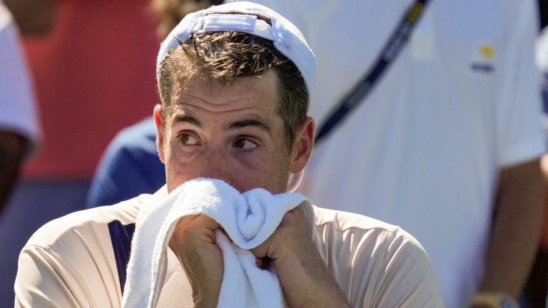 John Isner, of the United States, reacts after losing to Michael Mmoh, of the United States, during the second round of the U.S. Open tennis championships, Thursday, Aug. 31, 2023, in New York. (John Minchillo/AP)