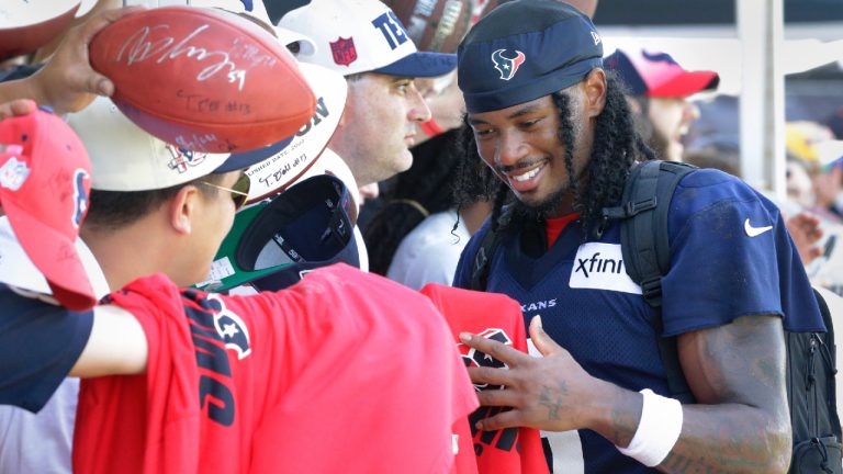 Houston Texans wide receiver John Metchie III gives autographs to fans after the NFL football team's training camp Sunday, July 30, 2023, in Houston. (Michael Wyke/AP)