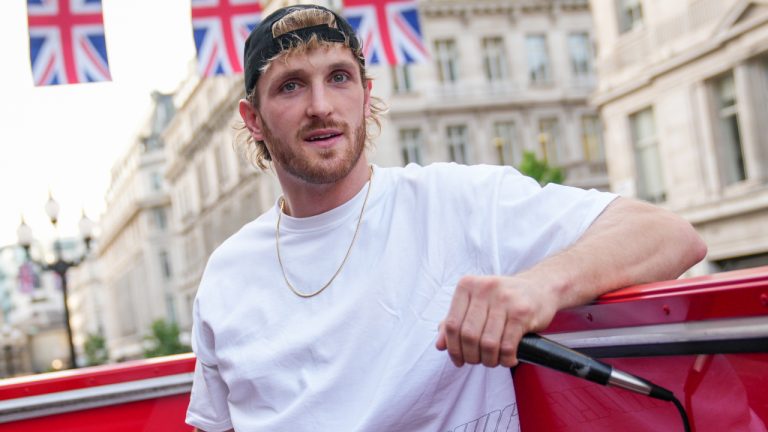 Logan Paul promotes an energy drink on an open top bus traveling through London, Friday, June 17, 2022. (Scott Garfitt/AP)