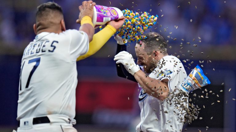 Tampa Bay Rays' Brandon Lowe is covered with gum and sunflower seeds by Isaac Paredes (17) after his walk off single off Colorado Rockies relief pitcher Brent Suter scored Osleivis Basabe during the 10th inning of a baseball game Wednesday, Aug. 23, 2023, in St. Petersburg, Fla. (Chris O'Meara/AP)