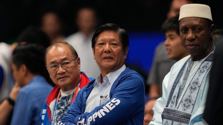 Philippine President Ferdinand Marcos Jr., center, watches the game beside FIBA president Hamane Niang, right, during a match of the Philippines against Dominican Republic at the Basketball World Cup at the Philippine Arena in Bulacan province, Philippines Friday, Aug. 25, 2023. (Aaron Favila/AP)