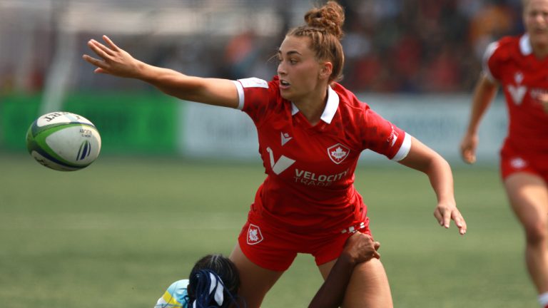 Canada's Chloe Daniels passes the ball away before being pulled down by St. Lucia's Renetta Fredericks during women's semi-final rugby action at the Rugby Sevens Paris 2024 Olympic qualification event at Starlight Stadium in Langford, B.C., Sunday, Aug. 20, 2023. (Chad Hipolito/CP)