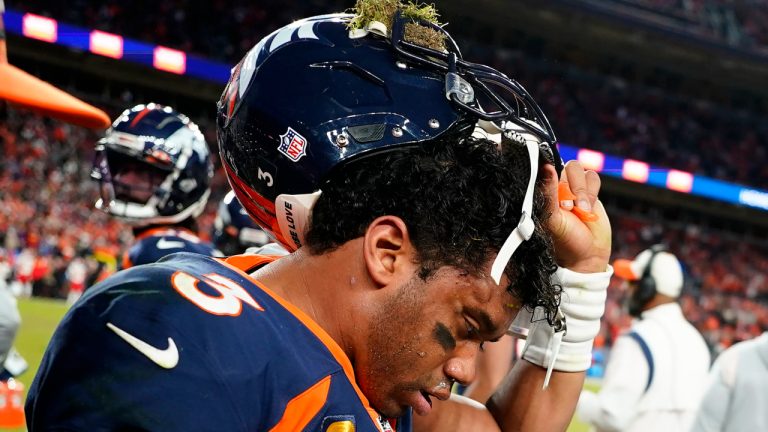 Denver Broncos quarterback Russell Wilson (3) removes his helmet after a concussion against the Kansas City Chiefs during the second half of an NFL football game, Sunday, Dec. 11, 2022, in Denver. (Jack Dempsey/AP)