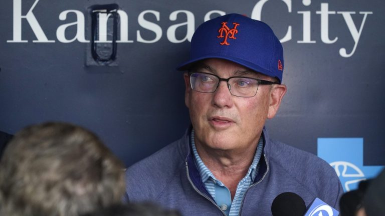 New York Mets owner Steve Cohen talks to the media in the dugout before a baseball game against the Kansas City Royals Wednesday, Aug. 2, 2023, in Kansas City, Mo. (Charlie Riedel/AP)