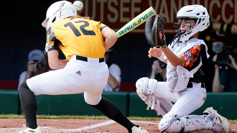 Nolensville, Tenn.'s Stella Weaver (12) ducks as she is hit by a pitch in the helmet from Smithfield, R.I.'s Brady McShane during the first inning of a baseball game at the Little League World Series tournament in South Williamsport, Pa., Friday, Aug. 18, 2023. (Tom E. Puskar/AP)