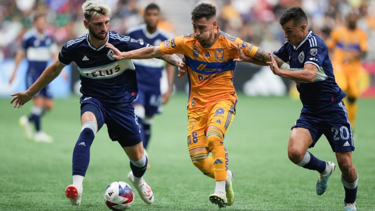 Tigres' Fernando Gorriaran, centre, vies for the ball against Vancouver Whitecaps' Tristan Blackmon, left, and Andres Cubas, right, during the first half of a Leagues Cup soccer match in Vancouver, on Friday, August 4, 2023. (Darryl Dyck/CP)