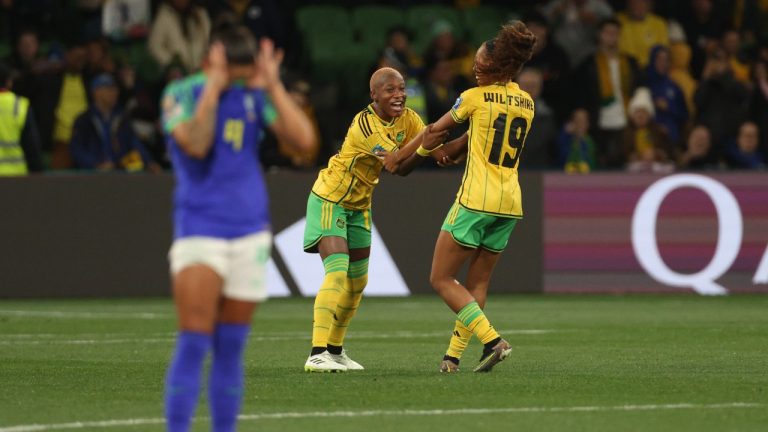 Jamaica's Deneisha Blackwood, centre, celebrates with her teammate Jamaica's Tiernny Wiltshire, after the Women's World Cup Group F soccer match between Jamaica and Brazil in Melbourne, Australia, Wednesday, Aug. 2, 2023. (Hamish Blair/AP)