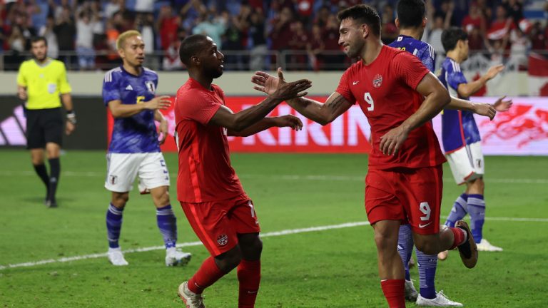 Canada's Lucas Cavallini, right, celebrates after he scored from a penalty kick during a friendly soccer match between Canada and Japan in Dubai, Thursday, Nov. 17, 2022. (Christopher Pike/AP)