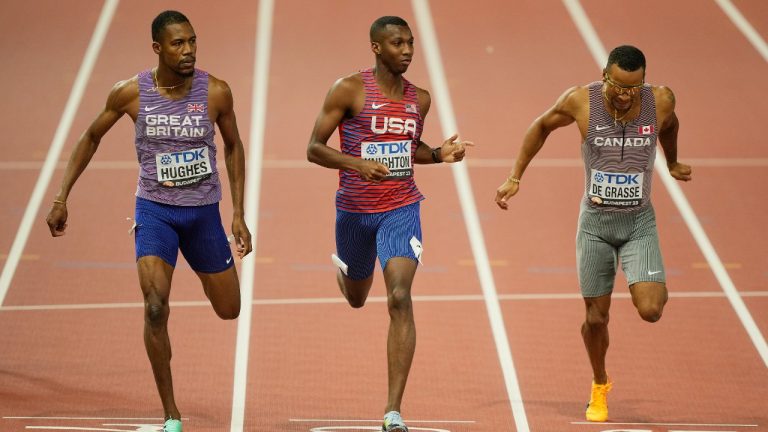 From left: Zharnel Hughes, of Great Britain, Erriyon Knighton, of the United States, and Andre De Grasse, of Canada, race to the finish in the Men's 200-meters semifinal during the World Athletics Championships in Budapest, Hungary, Thursday, Aug. 24, 2023. (Martin Meissner/AP)