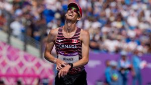 Evan Dunfee of Canada reacts as he crosses the finish line to win the men's 10,000 meters walk during the athletics in the Alexander Stadium at the Commonwealth Games in Birmingham, England, Sunday, Aug. 7, 2022. (Manish Swarup/AP)