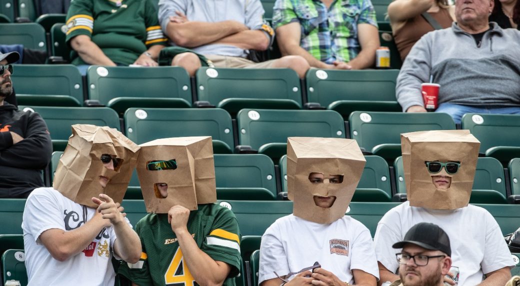 A New York Jets fan stands with a paper bag on his head in the 2nd