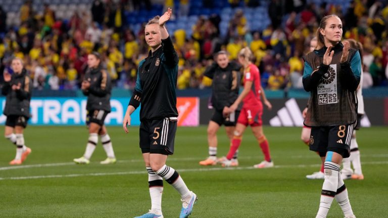 Germany's Marina Hegering, center, and Sydney Lohmann, right, applaud the fans at the end of the Women's World Cup Group H soccer match between Germany and Colombia at the Sydney Football Stadium in Sydney, Australia, Sunday, July 30, 2023. Colombia won 2-1. (Mark Baker/AP)