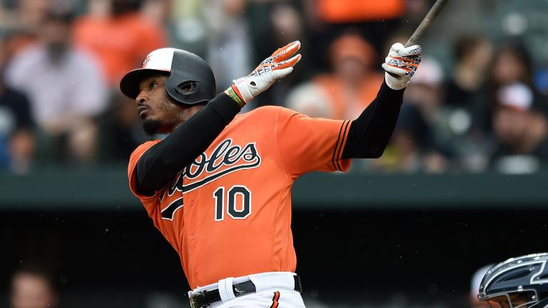 FILE - Baltimore Orioles' Adam Jones follows through on a solo home run against the New York Yankees in the first inning of baseball game June 2, 2018, in Baltimore. Jones will get one last hurrah at Camden Yards when the Orioles celebrate his retirement Sept. 15, 2023. The five-time All-Star has not played since finishing two years in Japan after the 2021 season. (Gail Burton/AP)