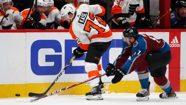 Philadelphia Flyers right wing David Kase, left, collects the puck along the boasrds as Colorado Avalanche center Tyson Jost defends in the first period of an NHL hockey game Wednesday, Dec. 11, 2019, in Denver. (David Zalubowski/AP)