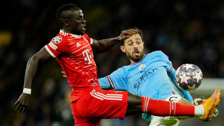 Bayern's Sadio Mane, left, fights for the ball with Manchester City's Bernardo Silva during the Champions League quarterfinal, first leg, soccer match between Manchester City and Bayern Munich at the Etihad stadium in Manchester, England, Tuesday, April 11, 2023. (Jon Super/AP)