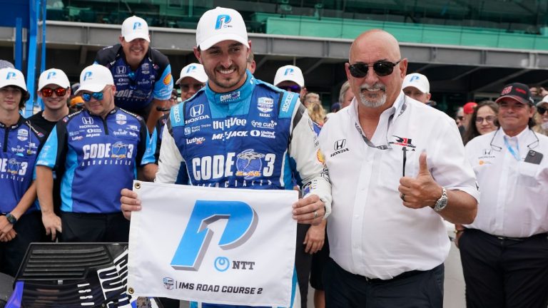 Graham Rahal, left, celebrates with his dad, Bobby Rahal, after winning the pole for the IndyCar Indianapolis GP at Indianapolis Motor Speedway, Friday, Aug. 11, 2023, in Indianapolis. (Darron Cummings/AP)