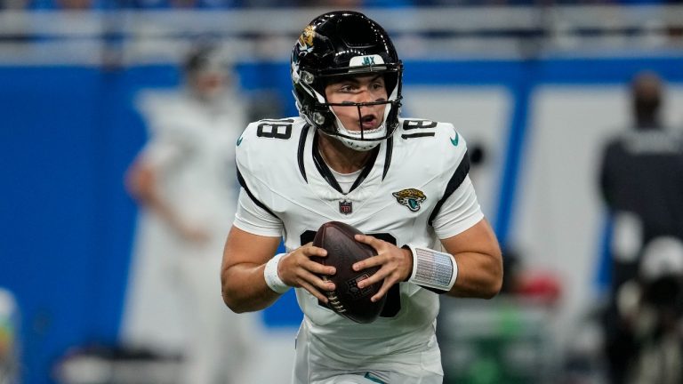 Jacksonville Jaguars quarterback Nathan Rourke (18) runs out of the pocket against the Detroit Lions during the second half of a preseason NFL football game, Saturday, Aug. 19, 2023, in Detroit. (Paul Sancya/AP Photo)