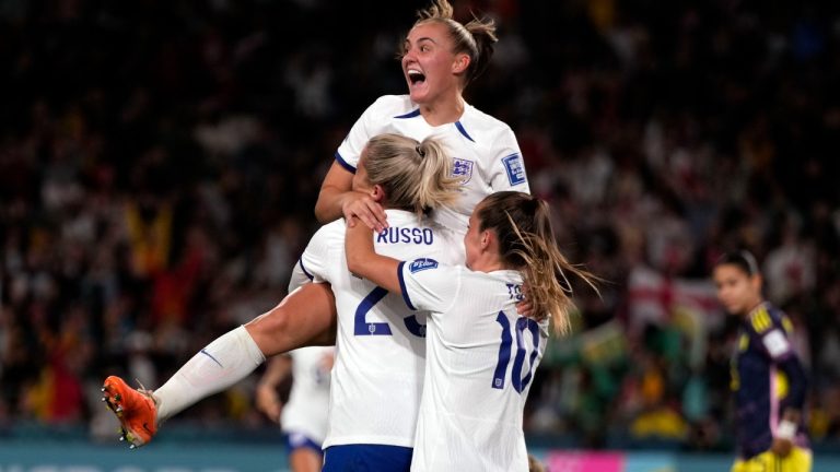 England's Alessia Russo , centre, is celebrated after she scored her side's second goal during the Women's World Cup quarterfinal soccer match between England and Colombia at Stadium Australia in Sydney, Australia, Saturday, Aug. 12, 2023. (Mark Baker/AP)