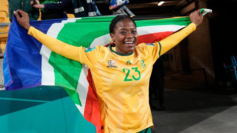 South Africa's Wendy Shongwe celebrates with the national flag after the Women's World Cup Group G soccer match between South Africa and Italy in Wellington, New Zealand, Wednesday, Aug. 2, 2023. (Alessandra Tarantino/AP)