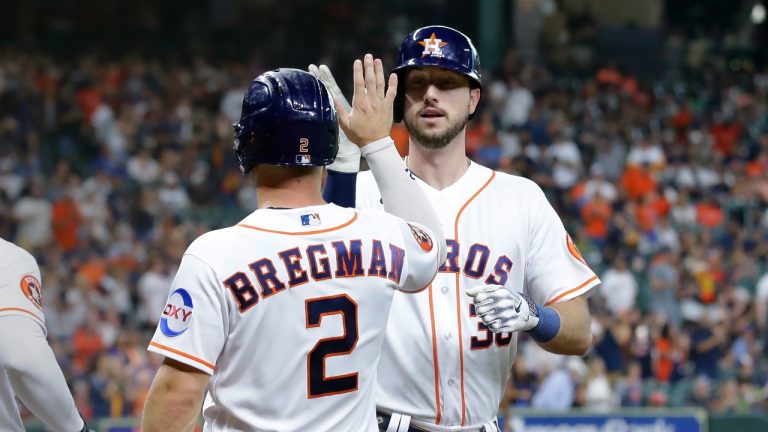 Houston Astros' Alex Bregman (2) and Kyle Tucker, right, celebrate after they both scored on the two run home run by Tucker against the Boston Red Sox during the first inning of a baseball game, Tuesday, Aug. 22, 2023, in Houston. (Michael Wyke/AP Photo)