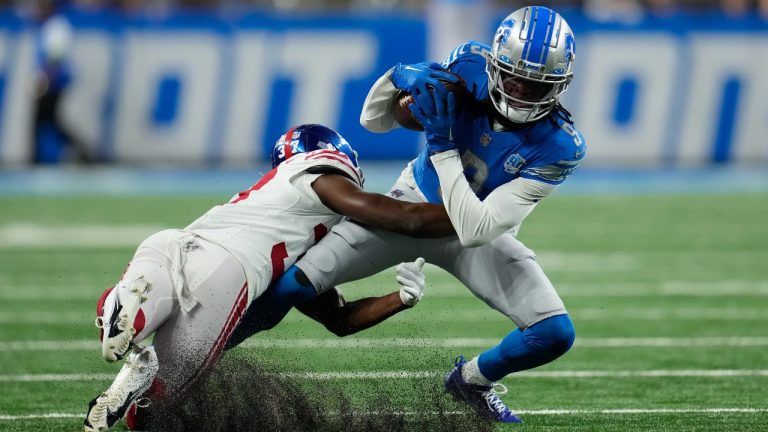 New York Giants cornerback Tre Hawkins III tackles Detroit Lions wide receiver Jameson Williams (9) during the first half of an NFL pre-season football game, Friday, Aug. 11, 2023, in Detroit. (Paul Sancya/AP)