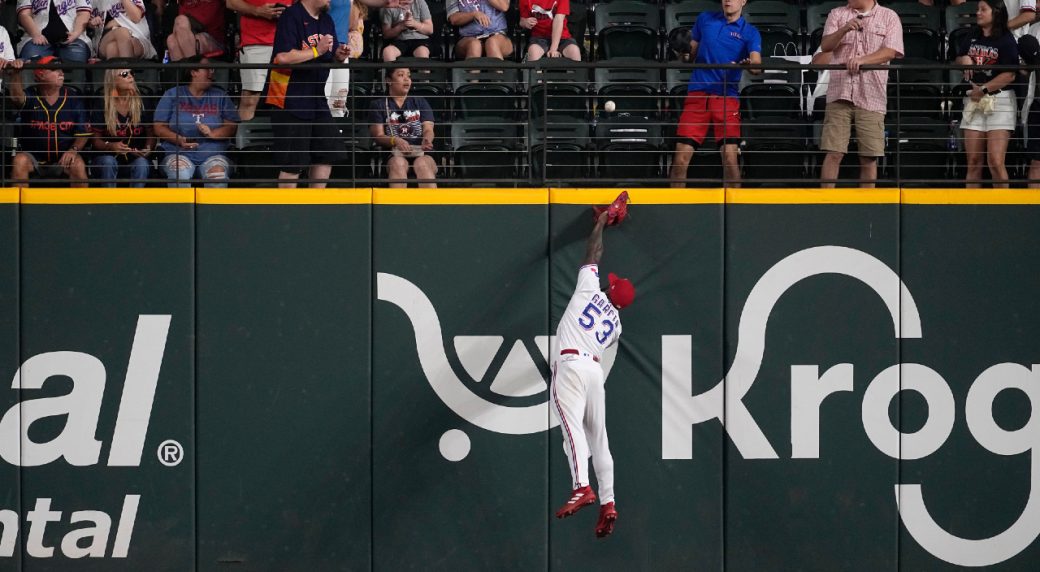 Adolis Garcia of the Texas Rangers fields a ball during the first