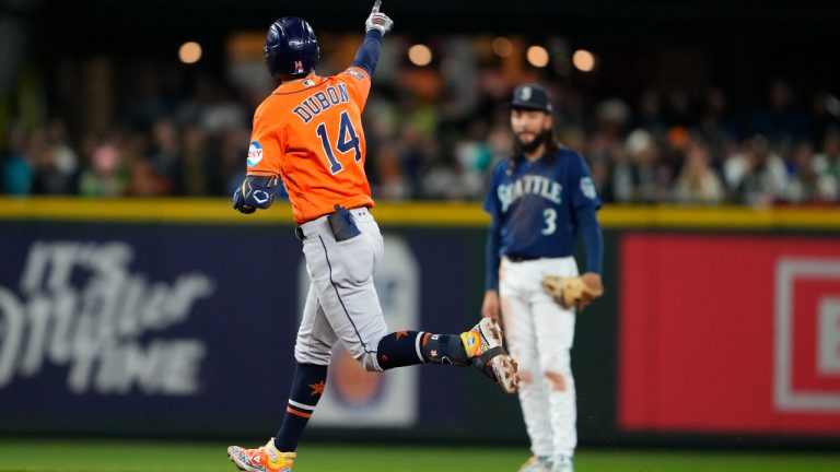 Houston Astros' Mauricio Dubon runs the bases after hitting a three-run home run, while Seattle Mariners shortstop J.P. Crawford (3) watches during the fourth inning of a baseball game Wednesday, Sept. 27, 2023, in Seattle. (Lindsey Wasson/AP)