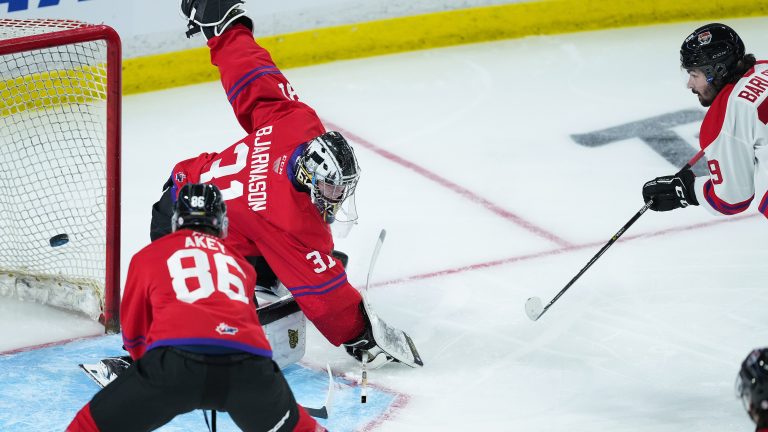 Team White's Colby Barlow, right, scores against Team Red goalie Carson Bjarnason (31) as Beau Akey (86) defends during the first period of the CHL/NHL Top Prospects game, in Langley, B.C., on Wednesday, January 25, 2023. (Darryl Dyck/CP)