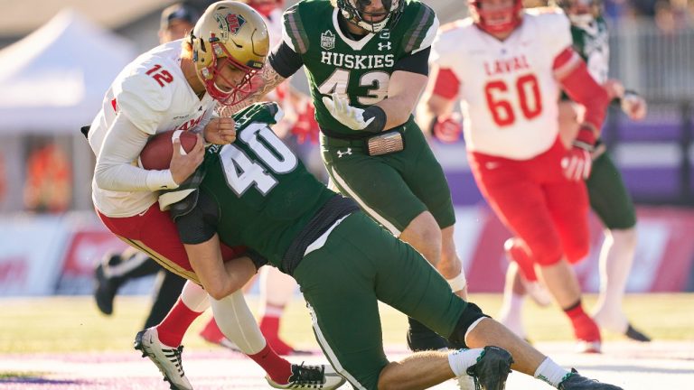 Laval Rouge et Or quarterback Arnaud Desjardins is tackled by Conner Delahey of the Saskatchewan Huskies during the first half of the Vanier Cup in London, Ont., Saturday, Nov. 26, 2022. (CP)