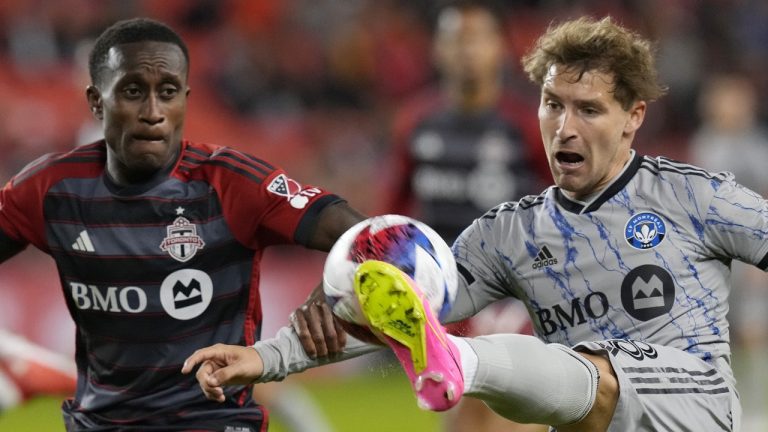 CF Montreal's Matko Miljevic (right) tries cross the ball past Toronto FC's Richie Laryea during second half Canadian Championship quarterfinal soccer action in Toronto on Tuesday, May 9, 2023. (CP)