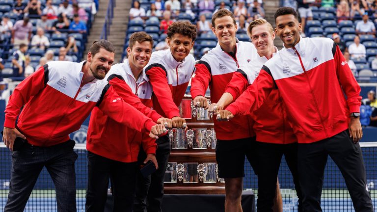 Canada's 2022 Davis Cup championship team Frank Dancevic, left to right, Alexis Galarneau, Gabriel Diallo, Vasek Pospisil, Denis Shapovalov, and Félix Auger-Aliassime pose with their rings, alongside the Davis Cup Trophy during a ceremony at the National Bank Open in Toronto, Monday, Aug. 7, 2023. (Cole Burston/CP)