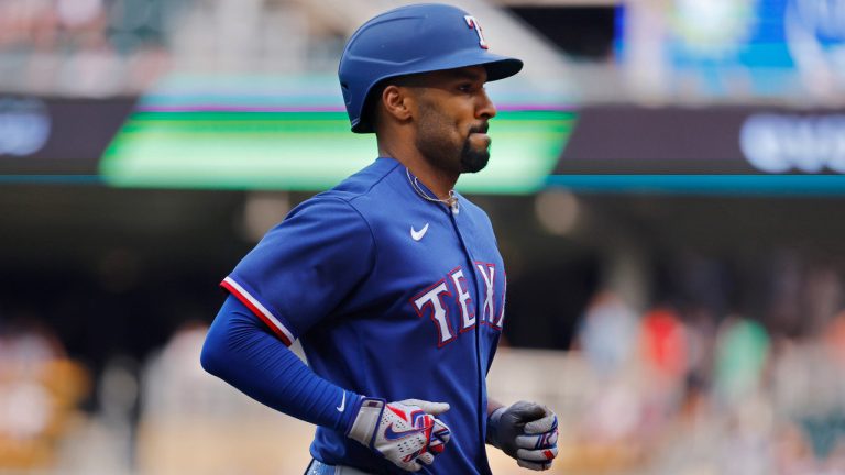 Texas Rangers' Marcus Semien runs the bases on his solo home run against the Minnesota Twins during the first inning of a baseball game Thursday, Aug. 24, 2023, in Minneapolis. (Bruce Kluckhohn/AP) 