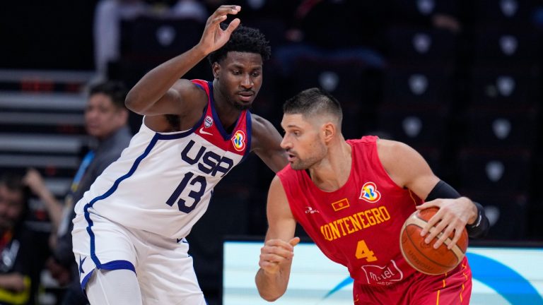 Montenegro center Nikola Vucevic (4) drives to U.S. forward Jaren Jackson Jr. (13) during the second half of a FIBA World Cup second round match in Manila, Philippines Friday, Sept. 1, 2023. (AP)