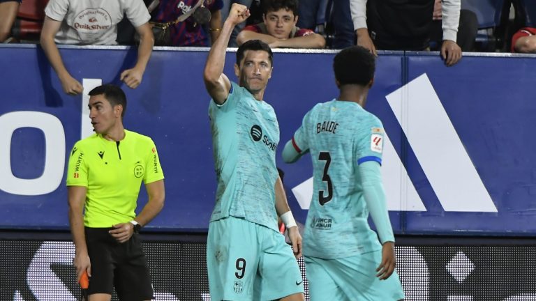 Barcelona's Robert Lewandowski celebrates scoring his side's 2nd goal from the penalty spot during Spanish La Liga soccer match between Osasuna and Barcelona at El Sadar stadium in Pamplona, Spain, Sunday, Sept. 3, 2023. (Alvaro Barrientos/AP)