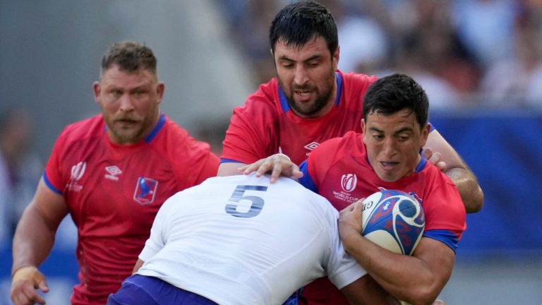 Chile's Marcelo Torrealba, right, is tackled by Samoa's Theodore McFarland during the Rugby World Cup Pool D match between Samoa and Chile at the Stade de Bordeaux in Bordeaux, France, Saturday, Sept. 16, 2023. (Christophe Ena/AP) 