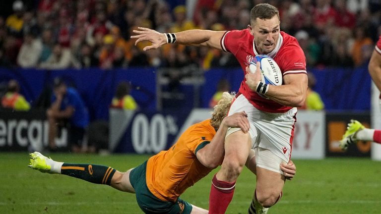 Wales' George North is tackled by Australia's Carter Gordon during a Rugby World Cup Pool C at the Parc OL stadium in Lyon, France, Sunday, Sept. 24, 2023. (Laurent Cipriani/AP) 