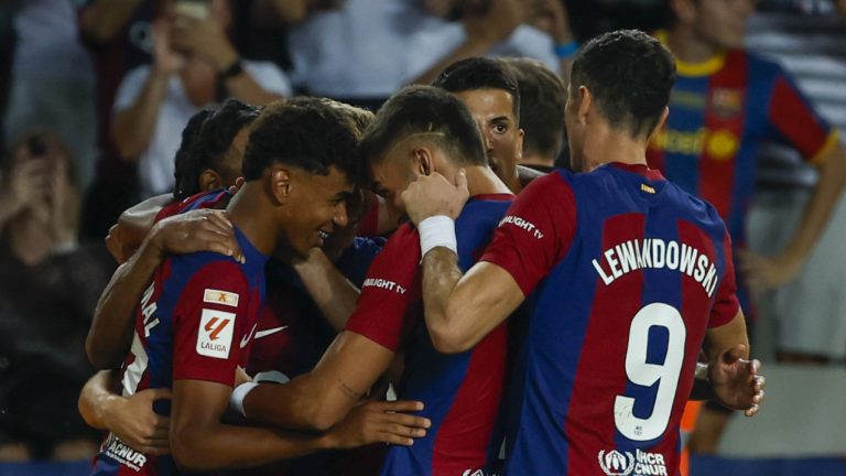 Barcelona players celebrate after Sevilla's Sergio Ramos scores an own goal past his goalkeeper during a Spanish La Liga soccer match between Barcelona and Sevilla, at the Olympic Stadium of Montjuic in Barcelona, Spain, Friday, Sept. 29, 2023. (Joan Monfort/AP)