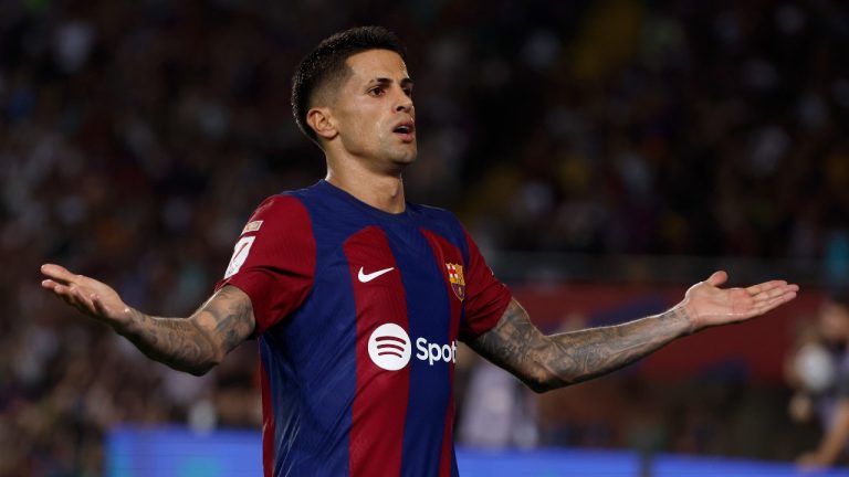 Barcelona's Joao Cancelo celebrates scoring his side's fifth goal during a Spanish La Liga soccer match between Barcelona and Betis at the Olympic Stadium. (Joan Monfort/AP)