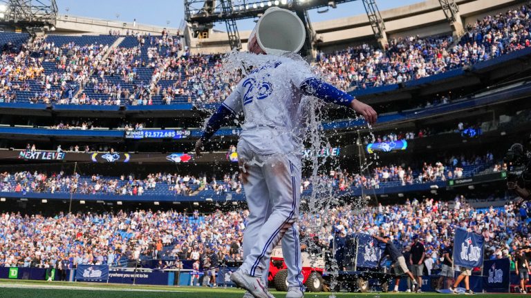 Toronto Blue Jays third baseman Matt Chapman (26) is doused by teammate Vladimir Guerrero Jr. (27) after hitting a walk-off double against the Boston Red Sox in American League MLB baseball action in Toronto, Sunday, Sept. 17, 2023. (Andrew Lahodynskyj/CP)