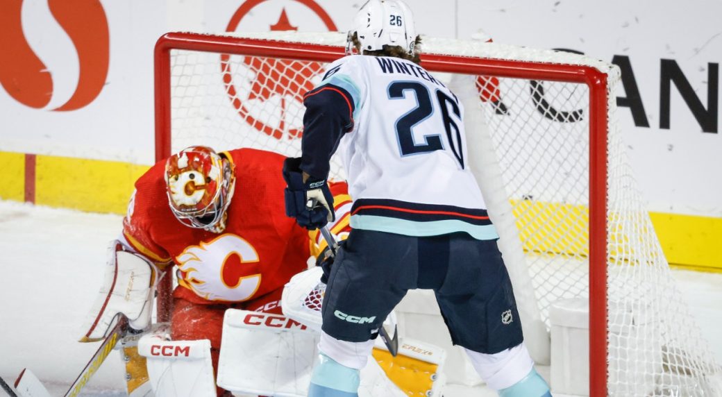 Seattle Kraken goalie Chris Driedger watches the puck during first