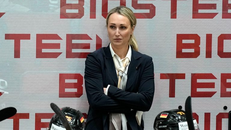 Germany's assistant coach Jessica Campbell stands behind players at the German bench during the group A Hockey World Championship match between France and Germany in Helsinki, Finland, Monday May 16, 2022. (Martin Meissner/AP)